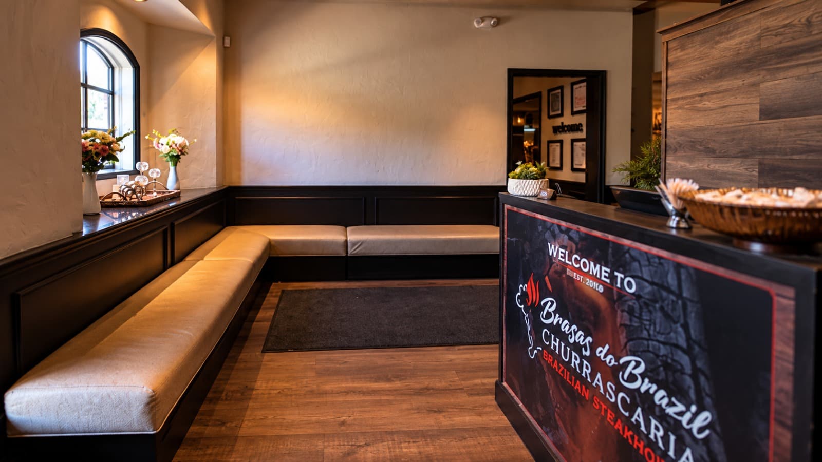 The Brasas do Brazil lobby, with the host stand that reads Welcome to Brasas do Brazil Churrascaria